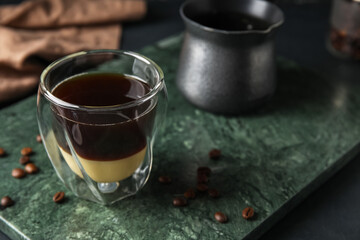 Glass of tasty Cafe Bombon on table
