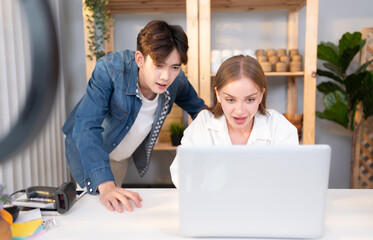 A young couple runs a small business. making clay ornaments Win the approval of the big project proposed to the customer.