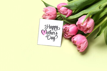 Fototapeta premium Greeting card with text HAPPY MOTHER'S DAY and beautiful tulip flowers on green background