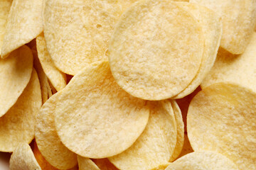 Delicious potato chips as background
