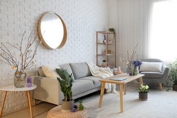 Interior of living room with sofa, armchair and Easter decor