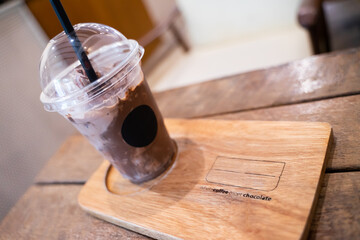 Iced chocolate mugs on wooden coasters with message when coffee meets chocolate - Powered by Adobe