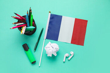Flag of France with stationery and crumpled paper on green background