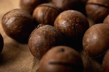 background, macadamia nuts close up view on gray background, tasty nut healthy food. Low key