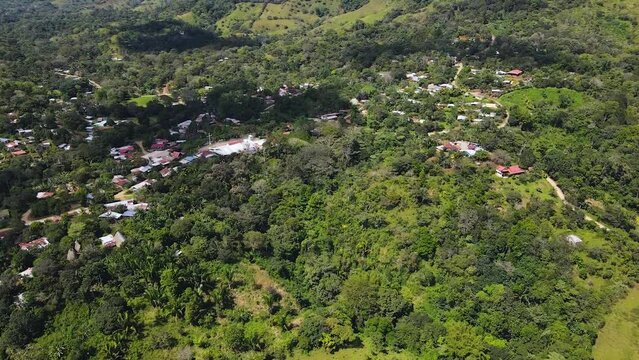 Aerial drone shot from the land of the Boruca community in Costa rica. Forward movement over houses and roads.
