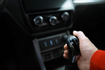 Close up view of a gear lever shift. Manual gearbox. Car interior details. Car transmission. Soft lighting. Abstract view