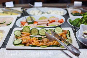Close up view of fresh deli meat served with vegetables.