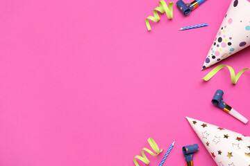 Composition with party hats, whistles, candles and serpentine on color background