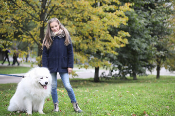 Lovely girl on a walk with a beautiful dog