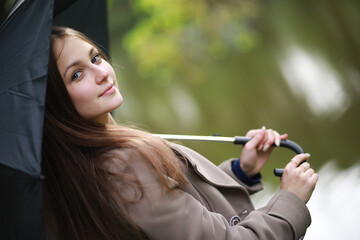 Young girl in a coat in a spring park