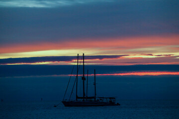 Dramatic tropical Florida sunset with yacht silhouette
