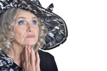 gorgeous mature woman in hat praying