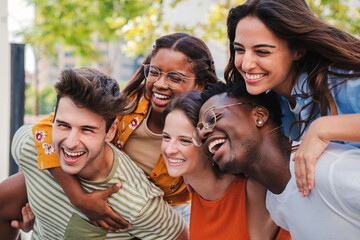 Close up portrait of a group of smiling multiracial teenage friends having fun outdoors. Cherful...