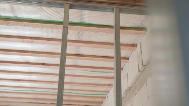 U-profile construction for a plasterboard frame partition. The ceiling of a private house hemmed with a vapor barrier. Smooth camera movement