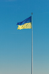 Ukrainian flag against the blue sky
