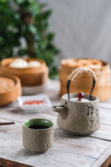 a cup of tea and dim sum on the wooden table