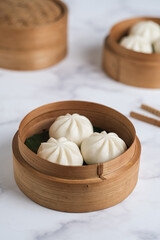 mini steam bun in bamboo basket