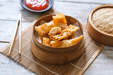 spring rolls , dim sum in bamboo basket