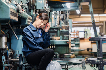 過労でやる気をなくす工場労働者の女性