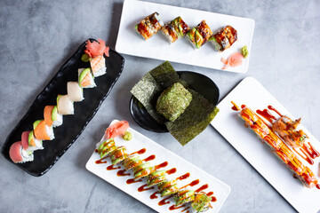 A top down view of several Japanese appetizers and entrees.