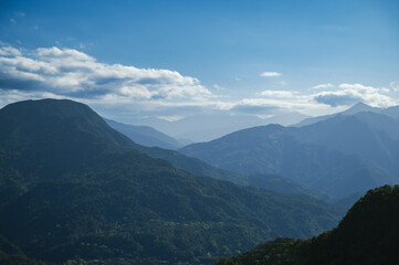 White clouds and blue sky above the green mountain. It's refreshing to the mind. Pay attention to climate change and industrial development. Taiwan