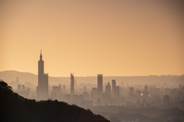 Silhouette of Taipei City at dusk. The sun moves towards the horizon. Pay attention to climate change and industrial development. Taiwan