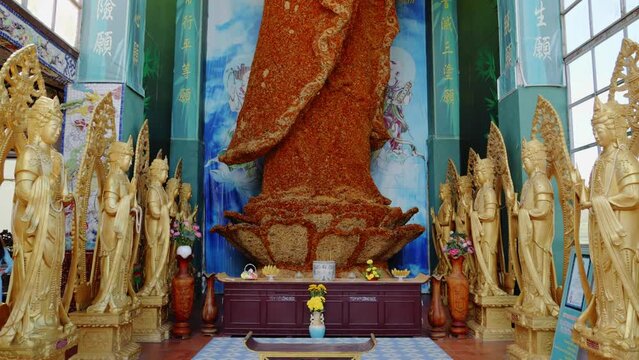 Buddhist Statue Made Of Flowers At Linh Phuoc Pagoda Temple In Vietnam, Southeast Asia. Tilt-up