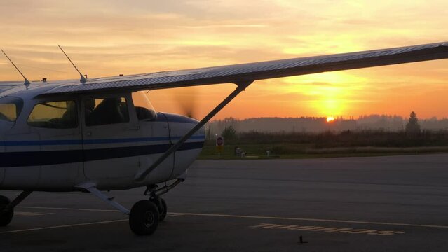 Cessna Plane Preparing To Fly At The Field During Sunset. static