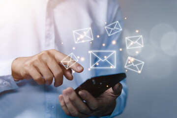 Businessman sending a letter from a smartphone. electronic mail concept is online communication on the Internet network Receiving	