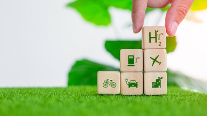 Businessman holding wooden block with hydrogen energy industry environment icon