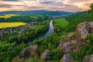 Spring landscape with blooming fields, green meadows and a meandering river in a valley under rocks. Discover the beauty of spring hiking