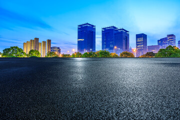 Asphalt road and city skyline with modern buildings at night in Shanghai, China. - obrazy, fototapety, plakaty