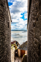 view of the beach between the buildings in Le Mont Saint-Michel, France