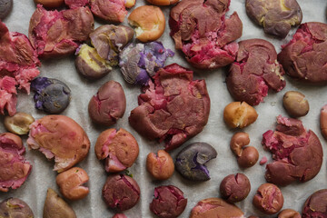 colored potatoes baked whole on a baking sheet in crushed form, delicious potatoes