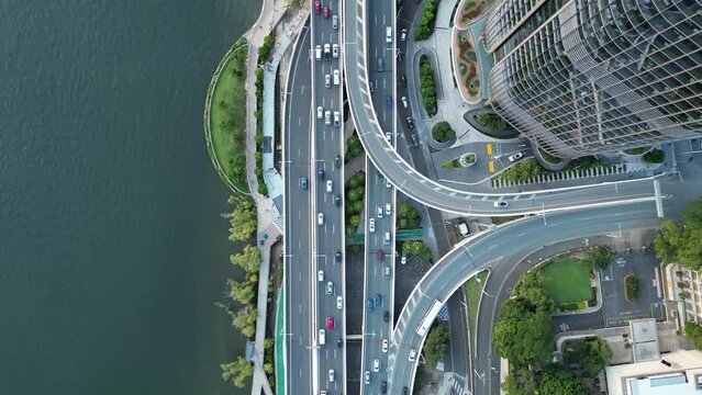 Top down drone shot from above Brisbane Expressway Motorway. With Brisbane City's new Queens Wharf Development in shot. Neville Bonner Bridge in shot. Busy traffic on the motorway below.