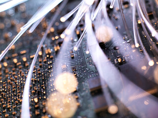 Close-up of illuminated fiber optics on circuit board of laptop computer