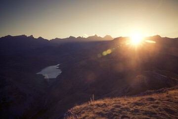 Idyllic view of lake and mountains against sky during sunset