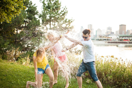 Friends Throwing Water Balloons At Eachother Laughing Hysterically