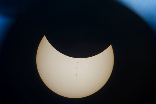 Crescent moon seen through astronomy telescope at night