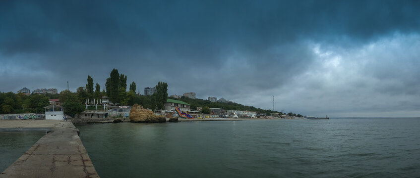 Otrada beach in Odessa, Ukraine, in a gloomy summer morning. Dark clouds asperatus over the sea until dawn.