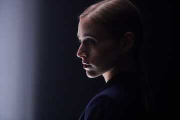 Side profile of a caucasian business woman with a serious expression on her face