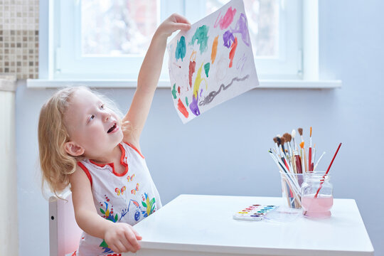 Todler is proud of his drawing. Kindergarten.