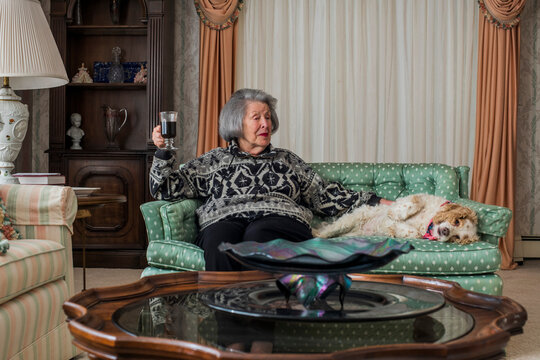 Grandma having coffee in the nice room with her dog