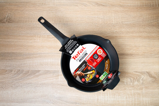 Zaporozhye, Ukraine - February 26, 2023: TEFAL ROBUSTO frying pan on the kitchen table. top view