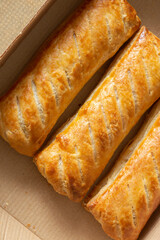 Sausage rolls in a cardboard takeaway tray. Sustainable biodegradable plastic free recycling packaging concept