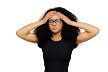 Image of beautiful woman feels unwell, touches forehead, suffers from headache, closes eyes from pain, being overworked, wears transparent glasses and casual t shirt, isolated over brown background