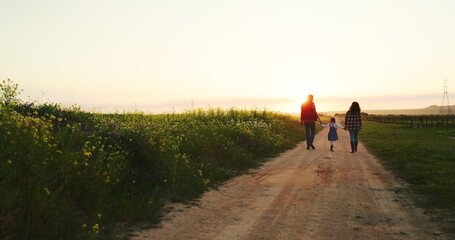 Man, woman or child holding hands on farm and sunset walking on nature environment path,...