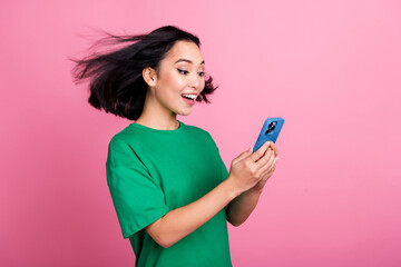Portrait of excited impressed woman straight hairstyle oversize t-shirt look at phone online...