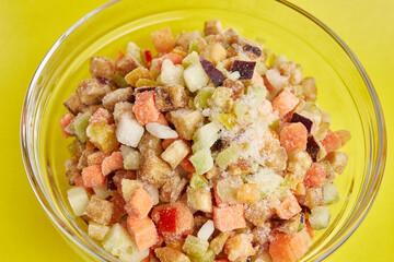 A bowl of chopped frozen vegetables. Cooking dishes from vegetables. Eggplants, tomatoes, zucchini, peppers, onions.