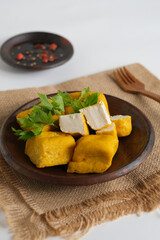 fried yellow tofu in plate